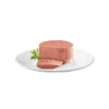 A piece of pâté on a white plate with a green leaf. Podgląd zdjęcia produktu