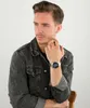 A man wearing a denim jacket and a watch. Voir les images du produit