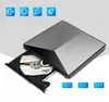 A silver and black external DVD drive with its tray open, displaying the internal components. Four blue icons are visible in the top left corner, and three blue buttons labeled 'VCD', 'CD', and 'DVD' are in the bottom right. Produktbild-Vorschau