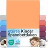 A stack of folded fitted sheets in various colors, with the main product in orange prominently displayed. A sleeping child is visible in the lower right corner. Náhľad obrázku produktu