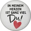 A round magnet with text and a heart graphic. Produktbild-Vorschau