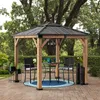 A gazebo set up on a patio with chairs and a table. Náhled obrázku produktu