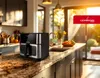 A modern kitchen counter with an air fryer and fruit bowl. Produktbild-Vorschau