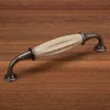 A drawer pull handle on a wooden surface. Produktbild-Vorschau