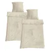 Two sets of bedding, each with a duvet cover and a pillowcase, are neatly folded and stacked against a white background. Produktbild-Vorschau