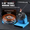 A welding positioner with a tiltable working table and a welding chuck, with sparks flying from a welding operation. Podgląd zdjęcia produktu