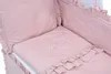 Close-up view of a pink baby crib with embroidered stars and a heart. Produktbild-Vorschau