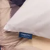A close-up of a bedding product with a label. Produktbild-Vorschau