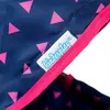 A close-up of a navy blue fabric with pink triangles, featuring a white label with the brand name 'kinderklap' in blue lettering. Produktbild-Vorschau