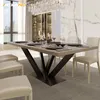 A dining room with a table and chairs, set for a meal. Voir les images du produit