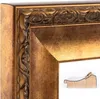 A close-up view of a decorative antique-style mirror frame with a small wooden piece in the foreground. Produktbild-Vorschau