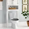 A white toilet with a black seat is shown in a bathroom setting, with a storage unit above it. Produktbild-Vorschau
