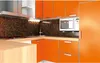 A modern kitchen with orange cabinets and a wooden countertop. Náhľad obrázku produktu