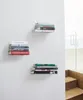 Three stacks of books are mounted on a white wall, each on a small floating shelf. The shelves are arranged diagonally across the wall. Anteprima dell’immagine prodotto