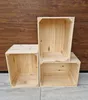Three wooden crates are stacked and arranged on a wooden floor against a wooden wall. Náhled obrázku produktu