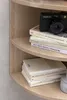 A close-up view of a wooden corner shelf with books and a camera. Náhľad obrázku produktu
