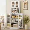 A white kitchen cabinet with glass doors and multiple shelves filled with kitchenware and food items. Produktbild-Vorschau