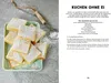 A plate of square-shaped cakes dusted with powdered sugar, next to a sieve and a recipe. Produktbild-Vorschau