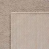 A close-up view of a beige bouclé rug, showing its textured weave. Podgląd zdjęcia produktu