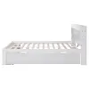 A side view of a white wooden bed frame with a slatted base and a headboard with storage compartments. Anteprima dell’immagine prodotto