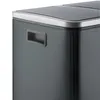 A close-up view of the side and top of a gray trash can. Voir les images du produit