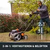 A man is using a lawnmower/cultivator in a garden. Produktbild-Vorschau