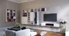 A modern living room with a wall-mounted entertainment unit and shelves. Produktbild-Vorschau
