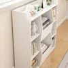 A white bookshelf filled with books and decorative items, placed next to a window. Podgląd zdjęcia produktu
