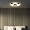 A modern bedroom with a unique ceiling light and a headboard with pillows. Produktbild-Vorschau