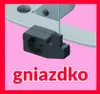 A close-up of an electrical socket adapter attached to a metal ironing board leg, with text overlay. Podgląd zdjęcia produktu