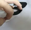 A hand is peeling a black sticker from a white backing sheet. Náhľad obrázku produktu