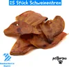 A pile of dog treats (pig ears) on a white background with text overlays and logos. Produktbild-Vorschau