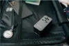 A travel adapter and a keychain are placed inside an open suitcase. Anteprima dell’immagine prodotto