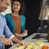 A couple preparing food in a kitchen. Anteprima dell’immagine prodotto