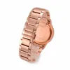 A close-up, side view of a rose gold watch with a metal band, isolated on a white background. Produktbild-Vorschau