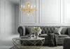 A luxurious living room with a tufted gray sofa, a marble coffee table, and a crystal chandelier. Anteprima dell’immagine prodotto
