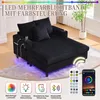 A black corduroy chaise lounge sofa with LED lighting underneath and on the side, shown with a remote control and a smartphone app interface. Voir les images du produit