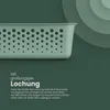 A close-up of a green storage basket with holes, set against a dark green background with concentric circles. Produktbild-Vorschau