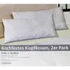 Two white pillows are shown on a bed, with a product information label below. Produktbild-Vorschau