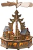 A wooden Christmas pyramid with a village scene and illuminated houses. Produktbild-Vorschau