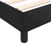A close-up view of the corner of a black upholstered bed frame with wooden slats visible inside. Náhled obrázku produktu