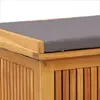 A close-up view of a wooden storage box with a gray cushion on top. Anteprima dell’immagine prodotto