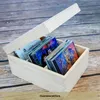 A wooden box filled with CDs, with the lid open and resting on a wooden surface. Produktbild-Vorschau