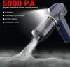 A dark background with a blue and gold portable vacuum cleaner emitting a stream of white smoke. Produktbild-Vorschau