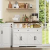 A white buffet-anrichte with drawers and cabinets, set in a kitchen or dining area with a window showing greenery outside. Produktbild-Vorschau