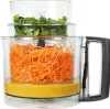 A food processor with shredded carrots and chopped herbs. Podgląd zdjęcia produktu