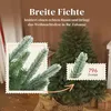 A close-up marketing image of a Christmas tree with text overlays highlighting its features. Produktbild-Vorschau