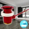 A red bathroom drain assembly with a white seal, set against a blurred background of a modern bathroom with a bathtub. Produktbild-Vorschau