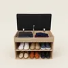 A shoe cabinet with a padded seat on top, open to reveal shelves with shoes and folded clothes. Podgląd zdjęcia produktu