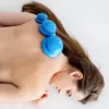 A person lying down with blue suction cups on their back. Náhľad obrázku produktu